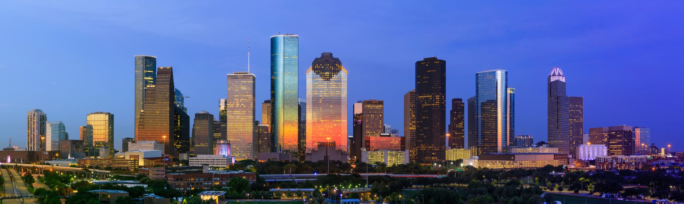 The Houston skyline at dusk, home of The Woodall Law Firm